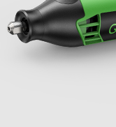 Close-up of a black and green electronic device with a metallic attachment. Partial view suggests it may be a grooming or styling tool.
