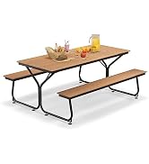 White circular outdoor dining set with round table and two curved benches. Black metal frames. Table set with food items and tableware.