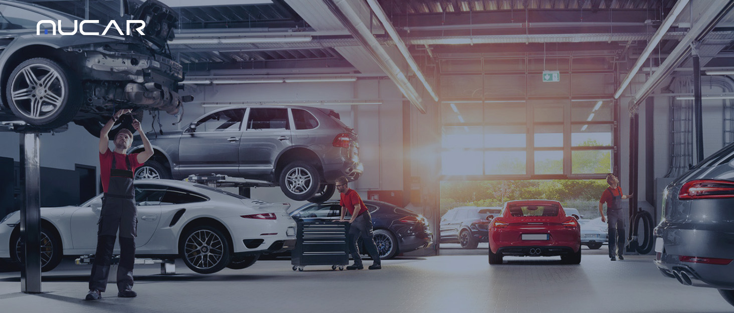 a man pushing a car in a garage