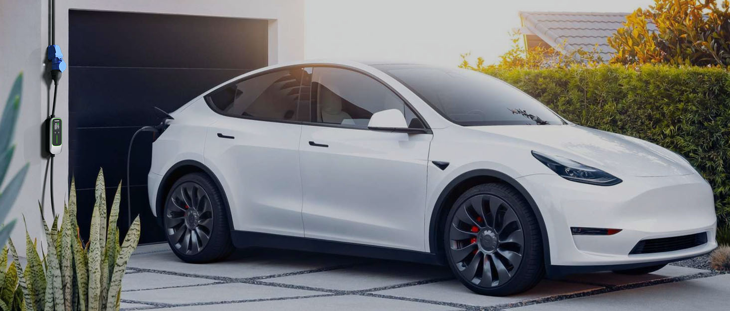 White Tesla Model Y electric SUV parked in modern garage with open driver door, featuring sleek design and alloy wheels.