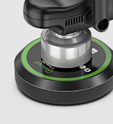 Green and black handheld electronic device or tool with elongated design and ergonomic grip.
