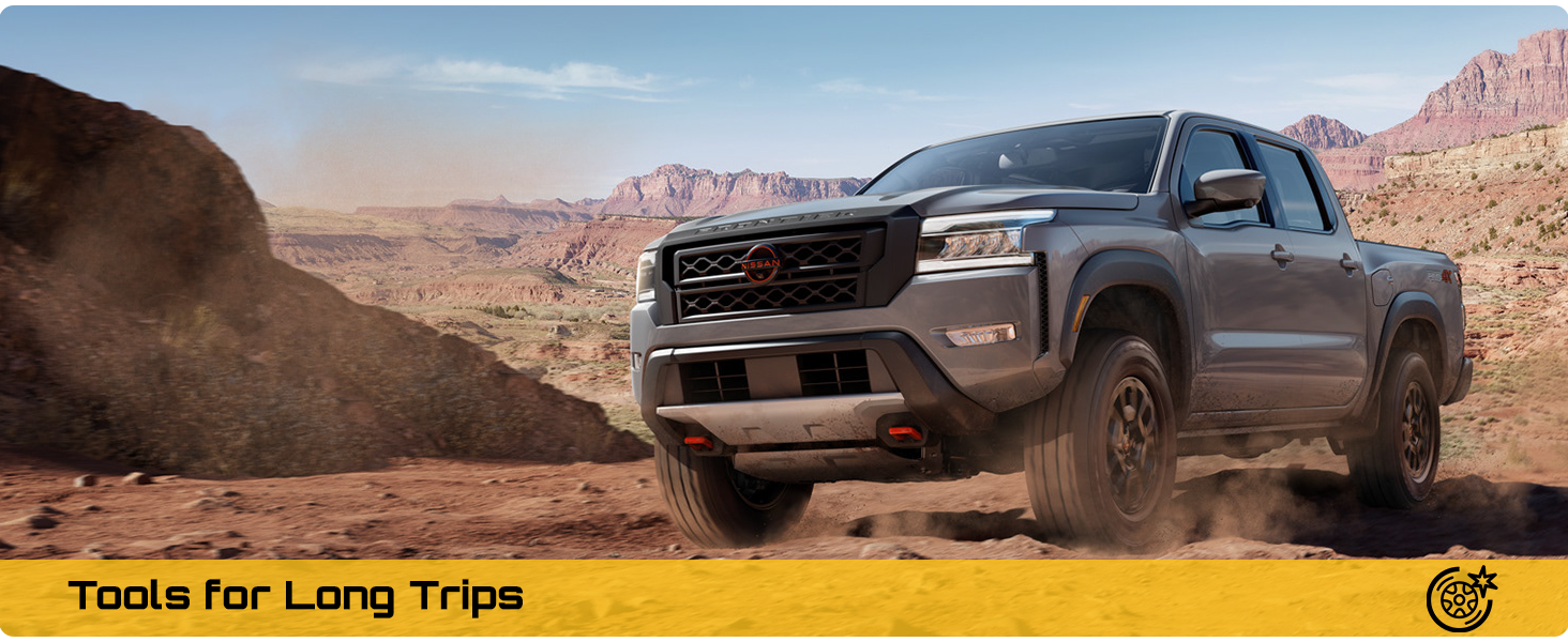 Text reads 'Tools for Long Trips'. Gray pickup truck driving through desert landscape with mountain backdrop, kicking up dust.