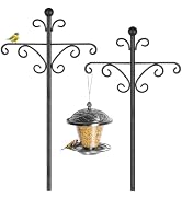 Decorative bird feeding station with ornate black metal cross-shaped stand featuring scrollwork. Four hanging feeders: dome feeder, wire cage feeder, ground tray, and rake tool attachment. Yellow bird perched on top.