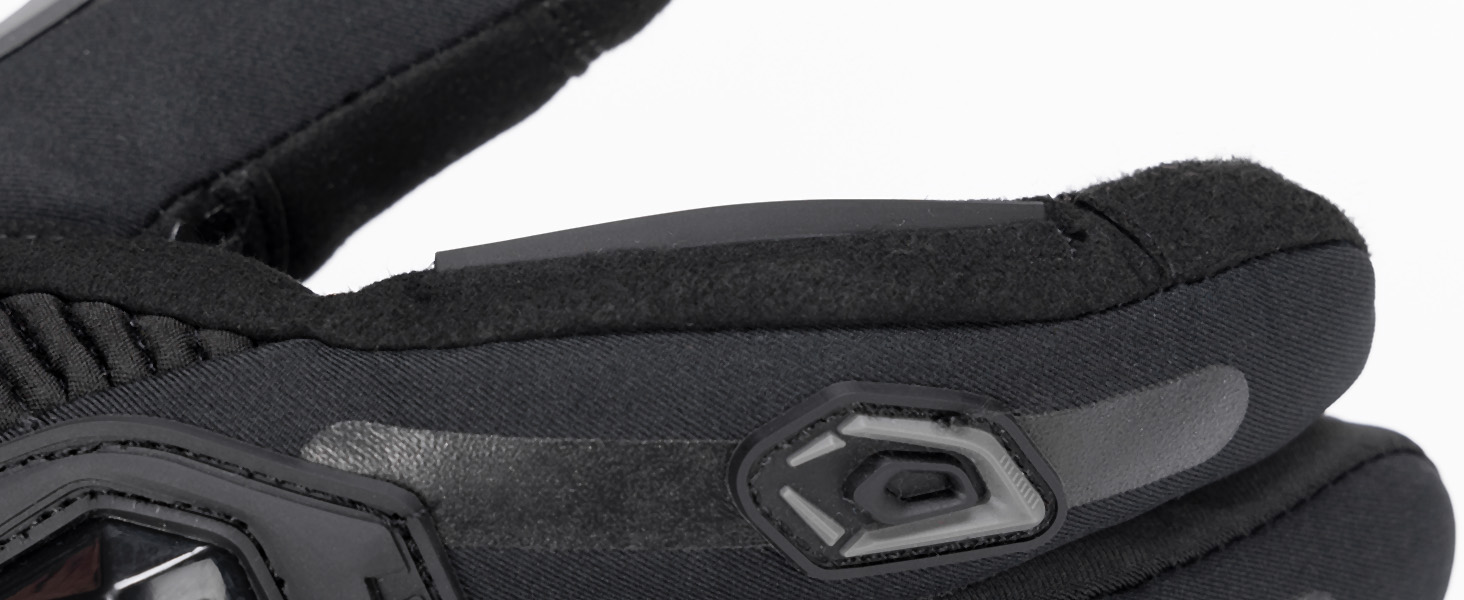 Close-up detail of black textured footwear showing rubberized sole pattern and reinforced material sections.