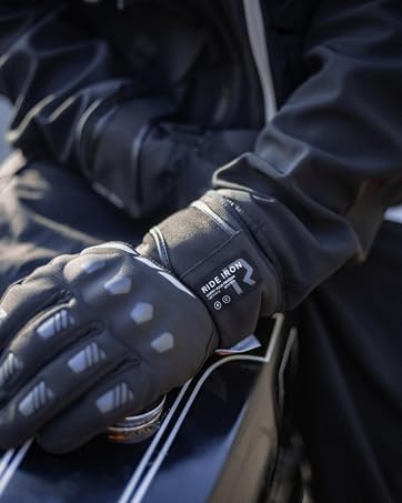 Black winter sports gloves with textured grip panels and reflective details. Close-up product shot showing pair against white background.