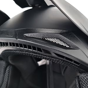 Black motorcycle or motocross helmet interior view showing protective padding and red safety strap fastener system. Matte black finish with red accent stitching.