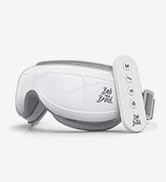 White eye massager device with interchangeable orange and blue accent pieces. Curved design suggests it fits over the eyes for relaxation or therapy.
