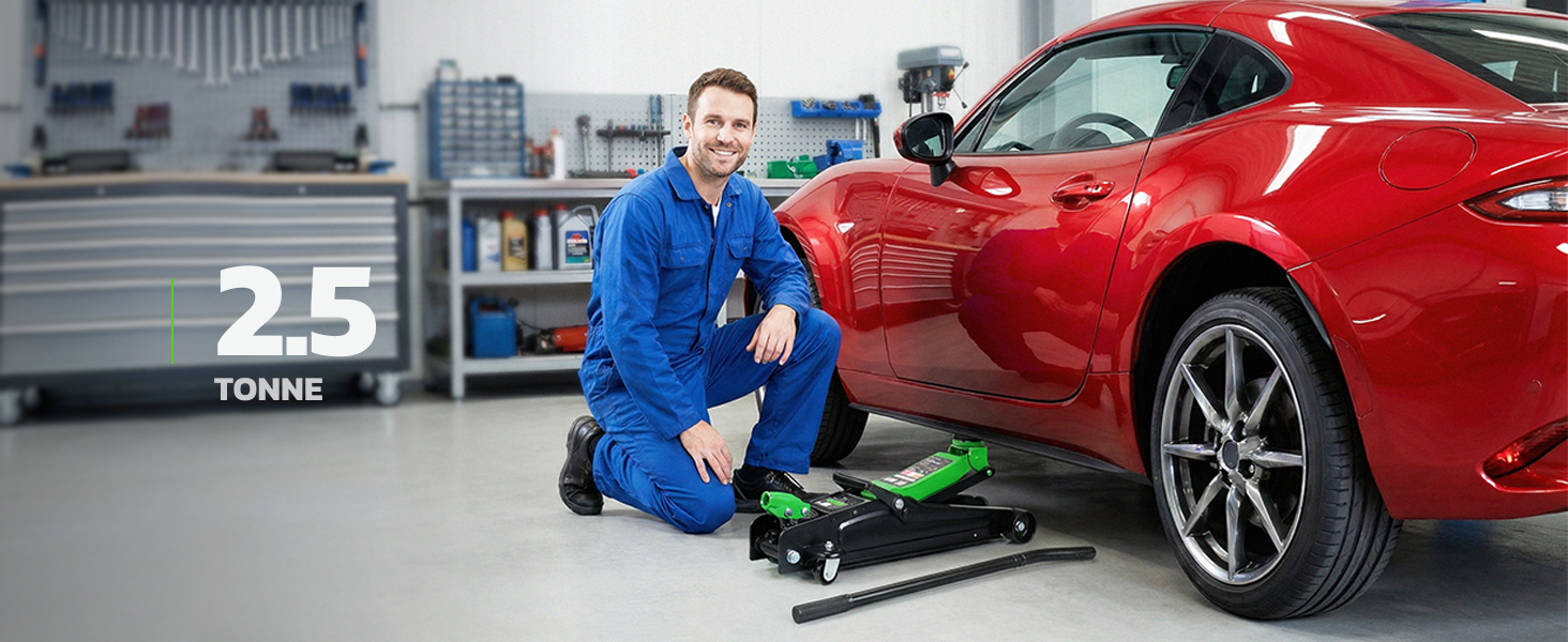 Text reads: '25 TONNE'. Shows mechanic in blue coveralls working underneath a red sports car using a floor creeper.