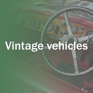 Text reads 'Vintage vehicles'. Interior view of classic car dashboard and steering wheel with green-tinted lighting.