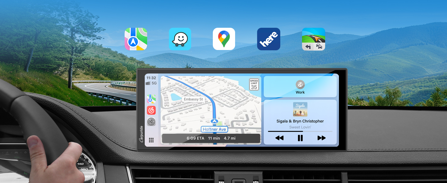 Car dashboard display showing navigation interface with map view and app icons at top. Wide rectangular screen mounted horizontally displays turn-by-turn directions against mountain scenery background.