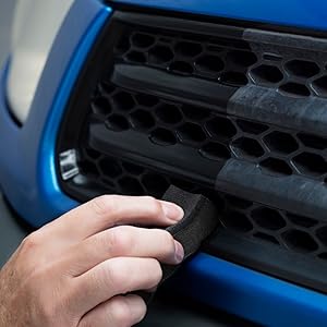 Close-up sequence showing hands interacting with a dark-colored textured surface, possibly machinery or equipment interface.