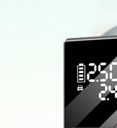 Close-up partial view of what appears to be dark electronic or technical equipment against a black background. Image is cropped and details are limited.