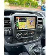 Vertical touchscreen display in vehicle dashboard showing grid of colorful app icons including music, phone, navigation, and utility applications.