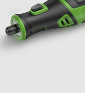 Partial view of a black and green plastic device or tool against a light gray background.