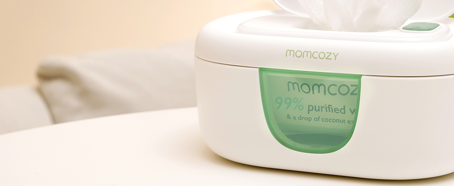 White cylindrical product container with green label shown in hand against neutral background. Container appears to be cosmetic or skincare product with minimalist design.