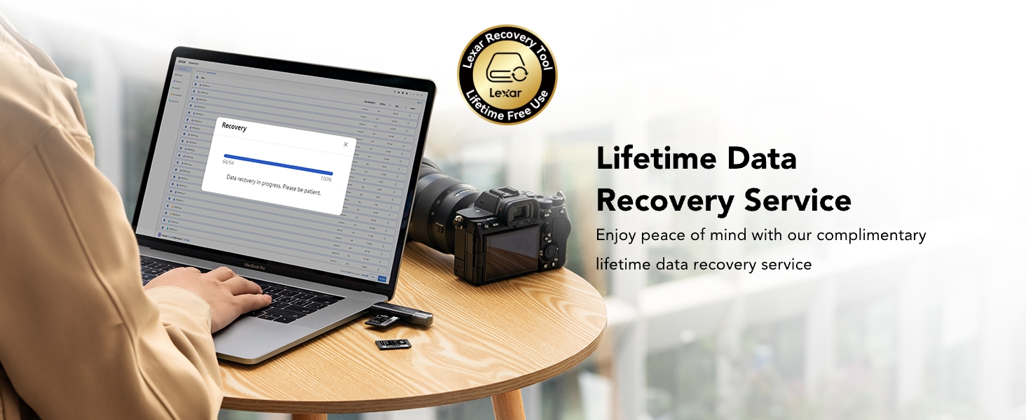 Laptop on desk with data recovery service information. Gold seal indicates lifetime warranty.