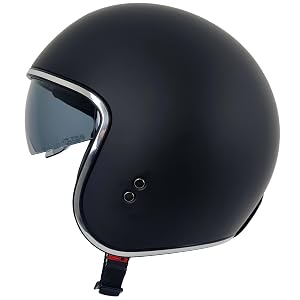 Matte black motorcycle helmet with clear visor shield, featuring chin strap with red accent and sleek aerodynamic design. Front-facing view on white background.