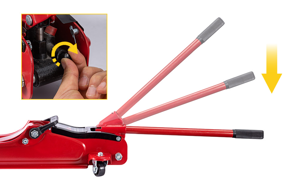 Red hydraulic floor jack lifting a vehicle's wheel. Close-up view shows the jack's lifting arm, wheels, and part of the car's brake rotor and suspension.