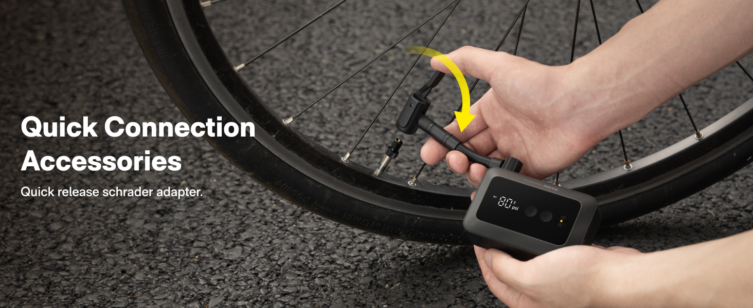 Quick-release bicycle cylinder adapter being attached to a bike tire, shown against dark textured ground.
