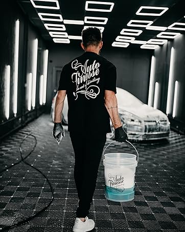 Promotional image for Auto Finesse car detailing products. Shows detailer working on a car with a branded bag in foreground. Highlights company's history since 1999 and excellent customer reviews.