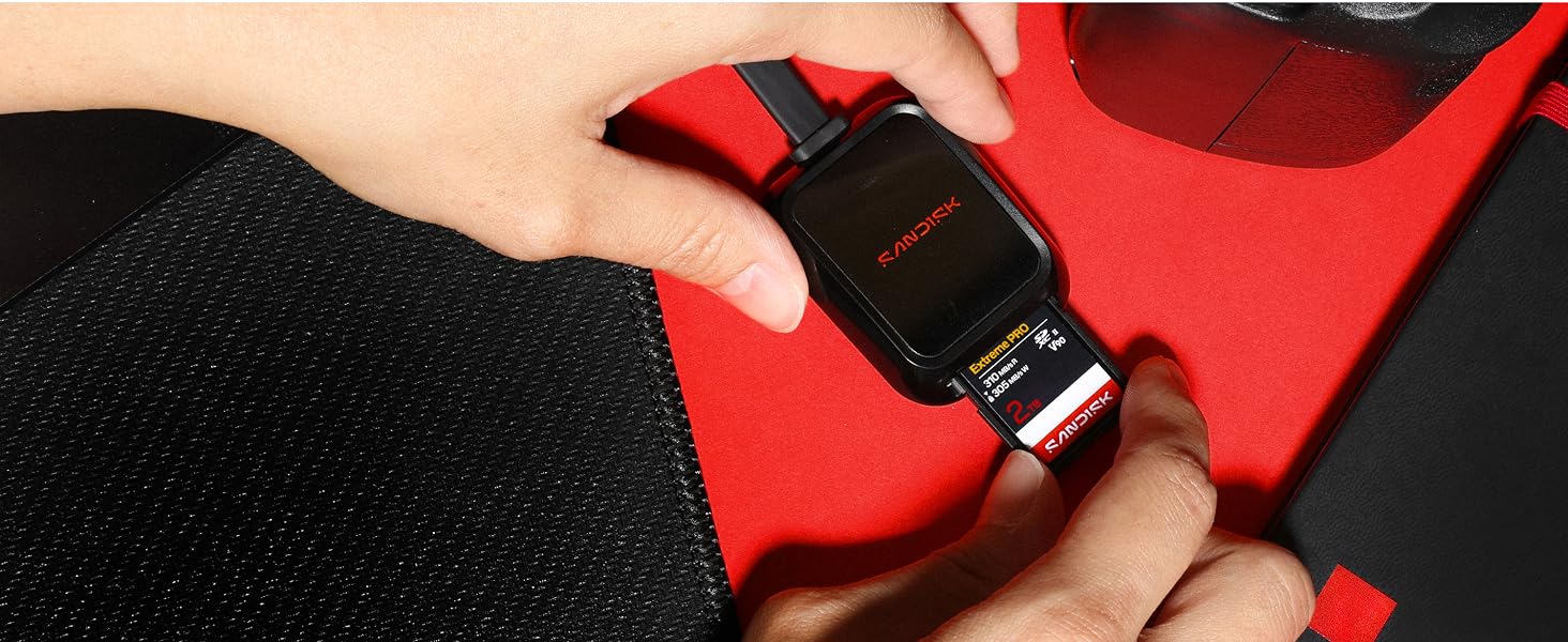 Close-up of hands wearing red and black padded boxing gloves against red fabric background, demonstrating hand protection equipment.