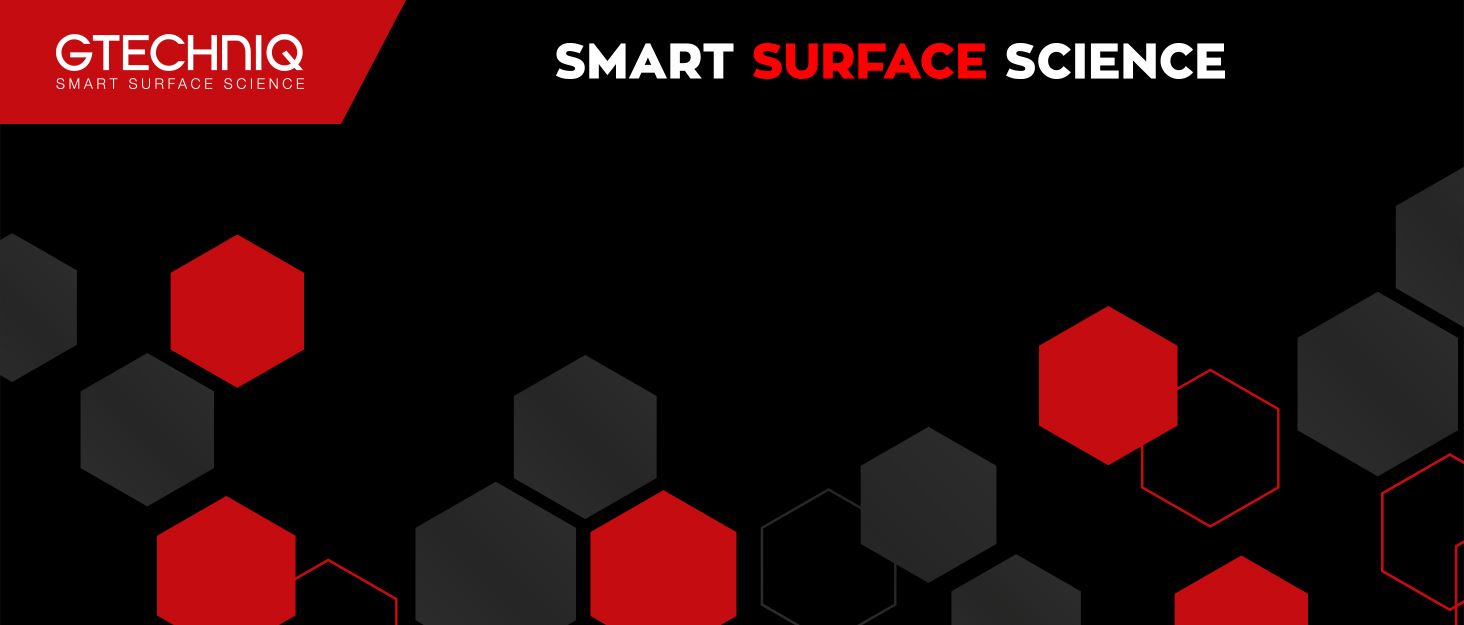 Abstract graphic with hexagonal shapes in black, gray, and red. Text reads 'GTECHNIQ SMART SURFACE SCIENCE' against a black background.