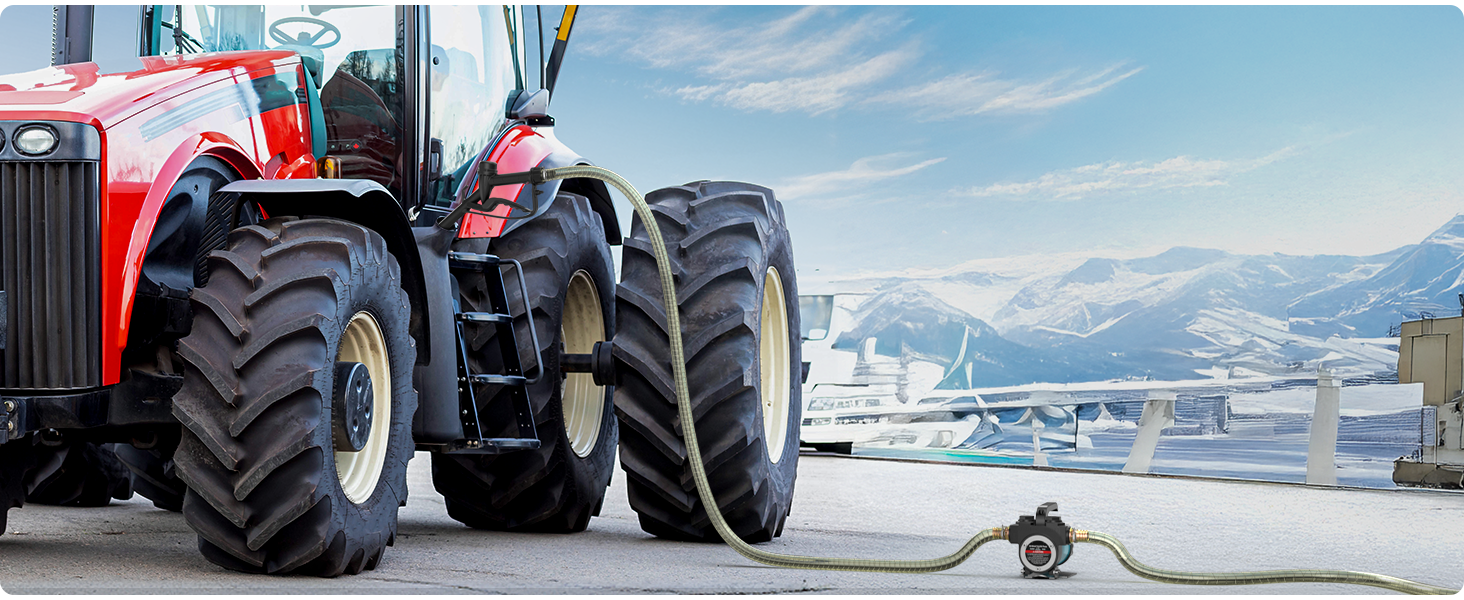 Series of snow tires on large agricultural or construction vehicles shown in winter mountain setting with snow-covered landscape.
