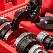 Open red carrying case with black foam insert compartments containing multiple tool attachments and accessories organized in organized rows.